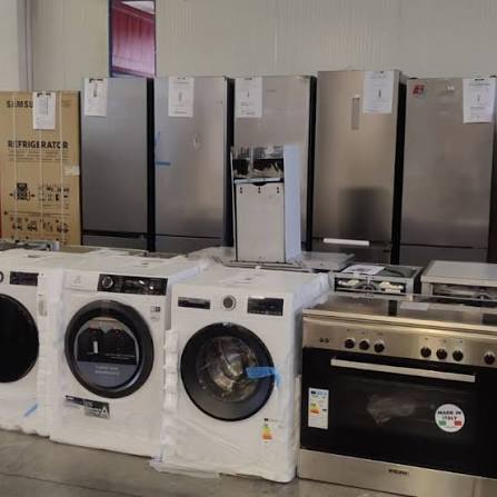 Warehouse row of washing machines, refrigerators and cookers